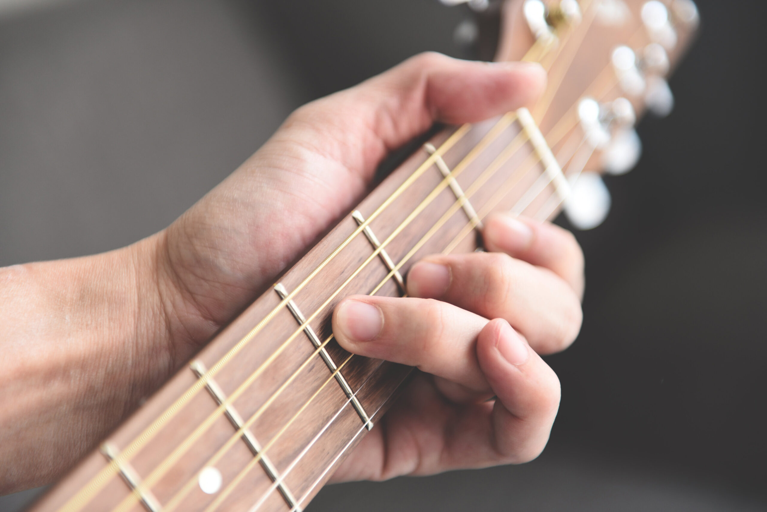 Home hobbies concept, Man hands playing acoustic guitar, close up guitar player Musical instrument for recreation or hobby passion